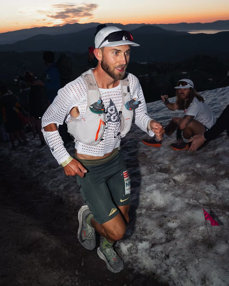 Runner cresting a ridge at sunrise in the Radical AirFlow top